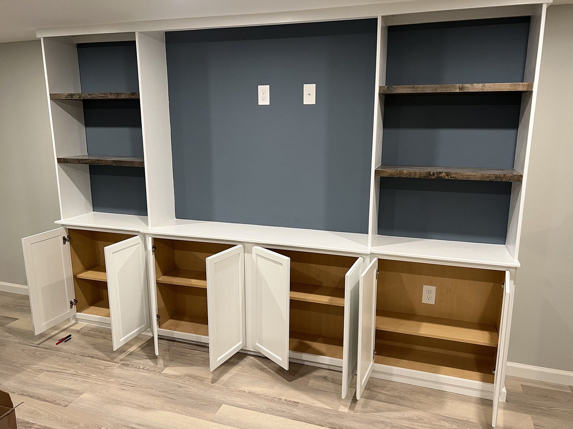 Custom basement bar with blue cabinets and white subway tile