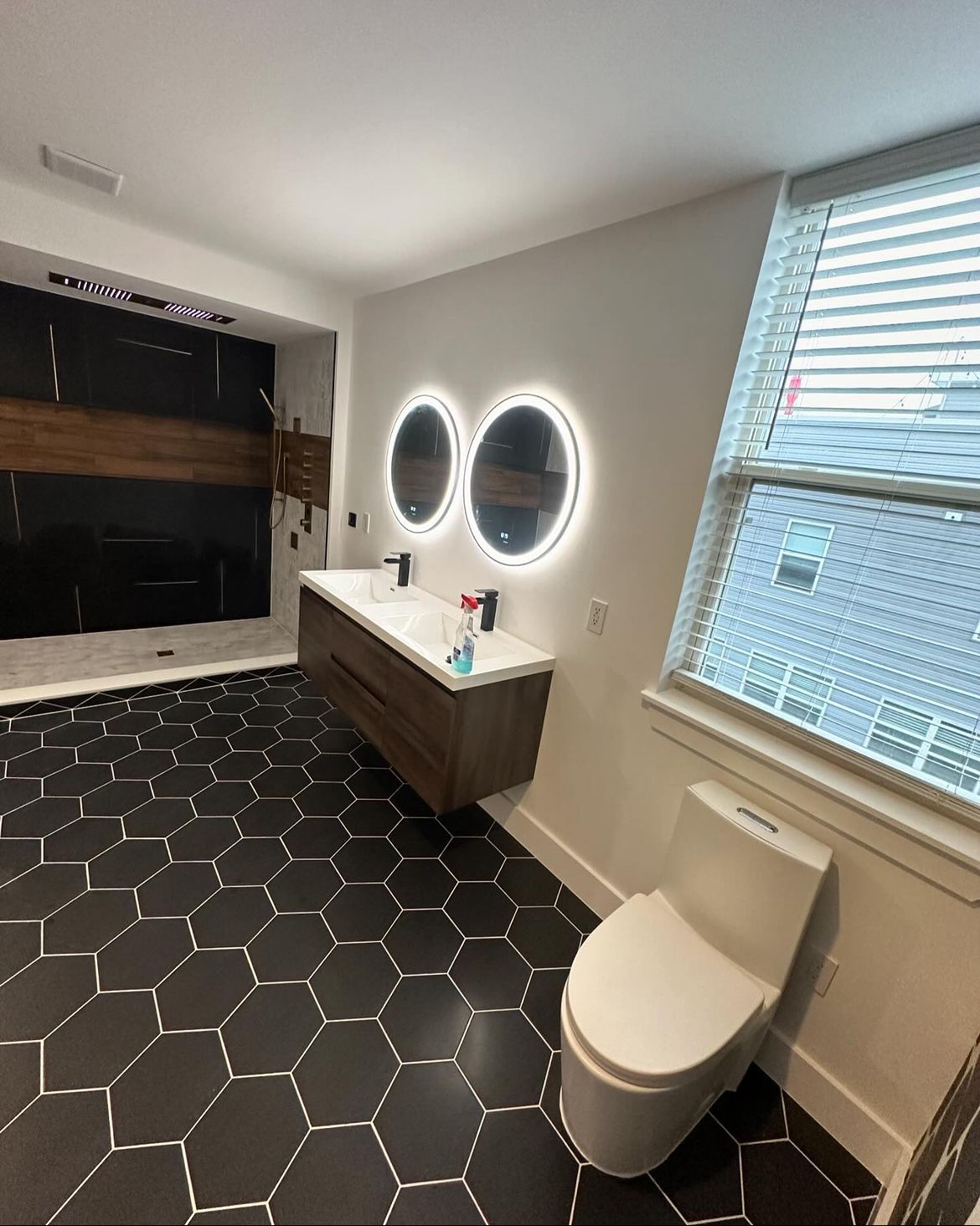 Vanity and window with dual mirrors and black hex floor