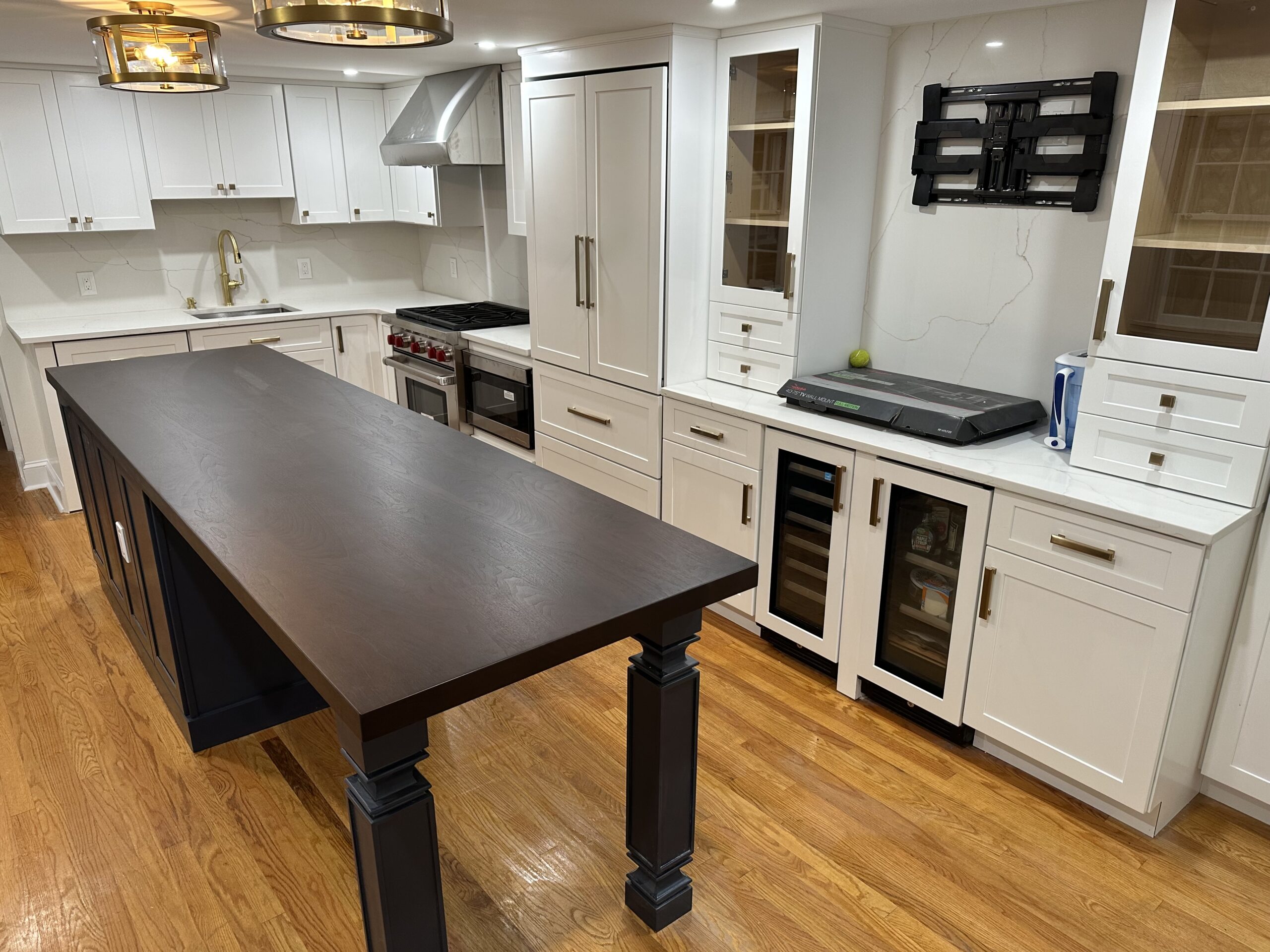 Full modern kitchen renovation with white cabinets and dark island in Collingswood NJ