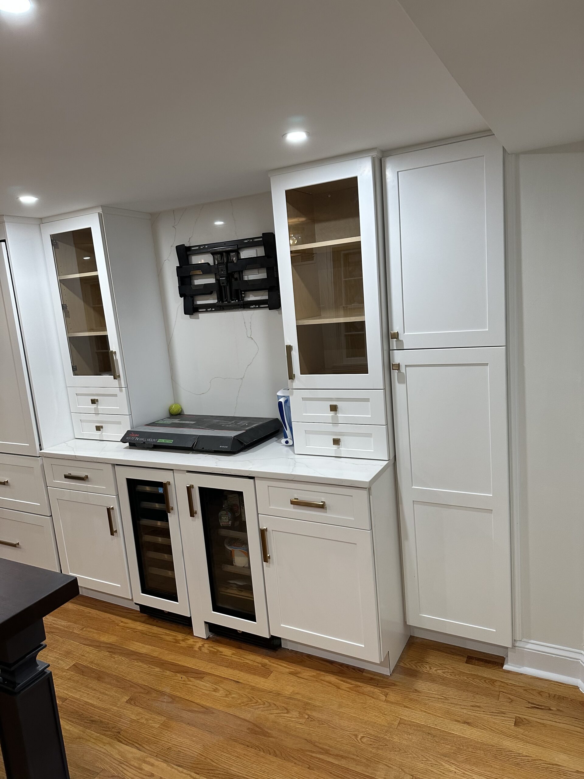 Stainless steel range and range hood in modern white kitchen renovation