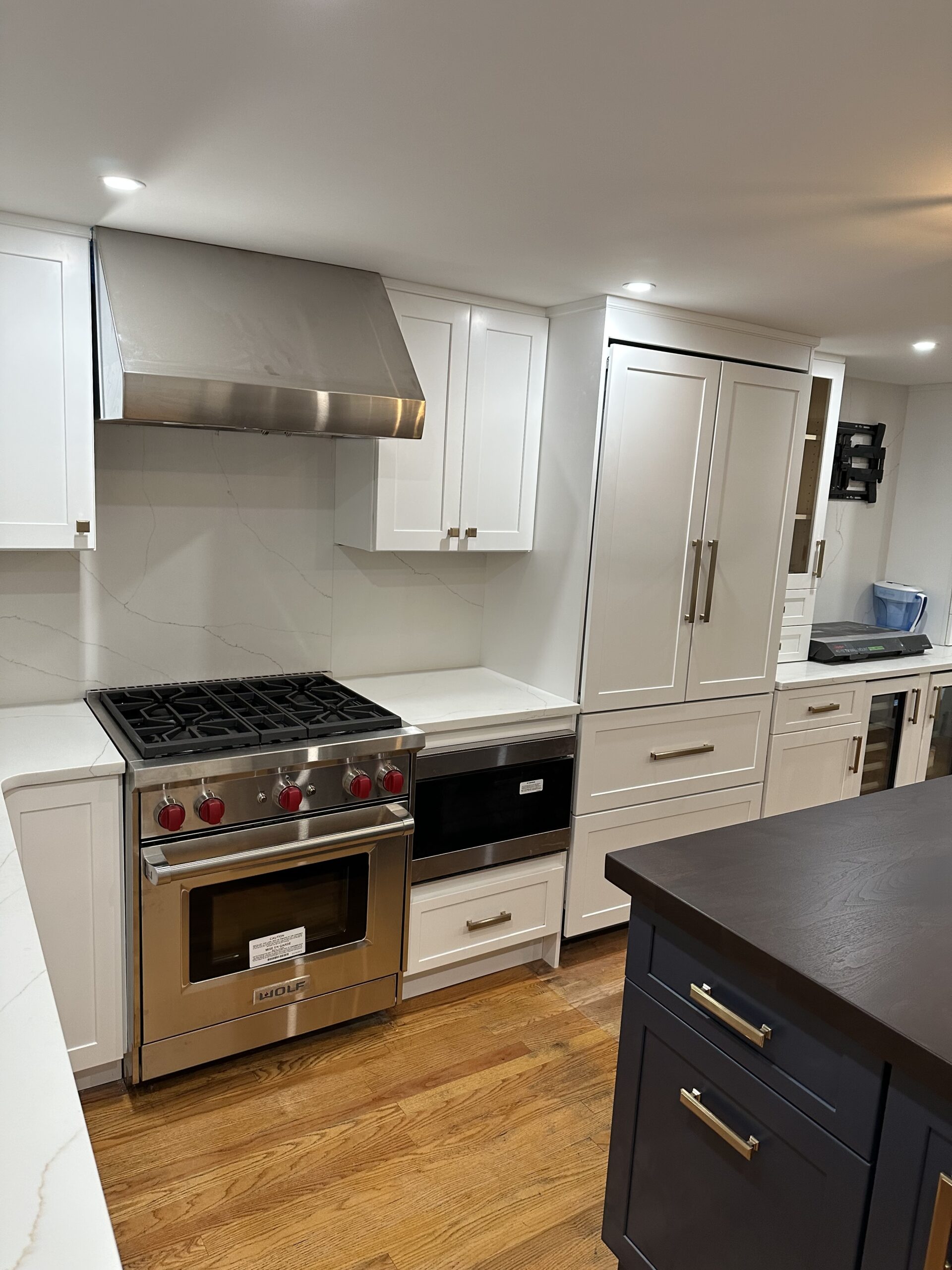 Kitchen island with dark countertop and stainless steel appliances
