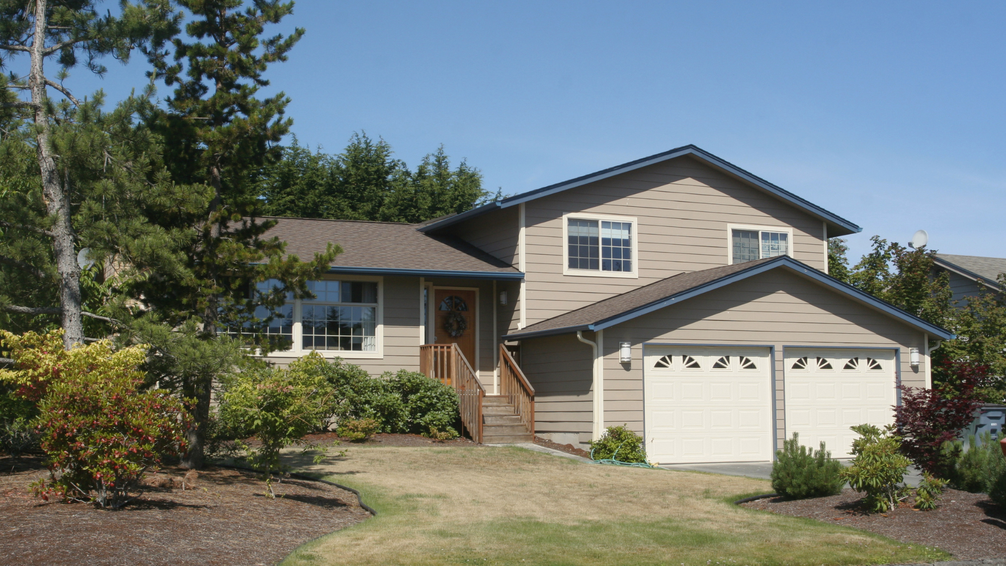 Side-split style split-level house with an attached two-car garage and a raised front entry