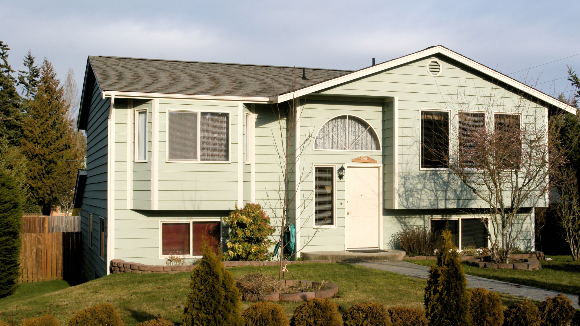 Bi-level raised ranch style split-level house with a front-gable entry and windows on both levels